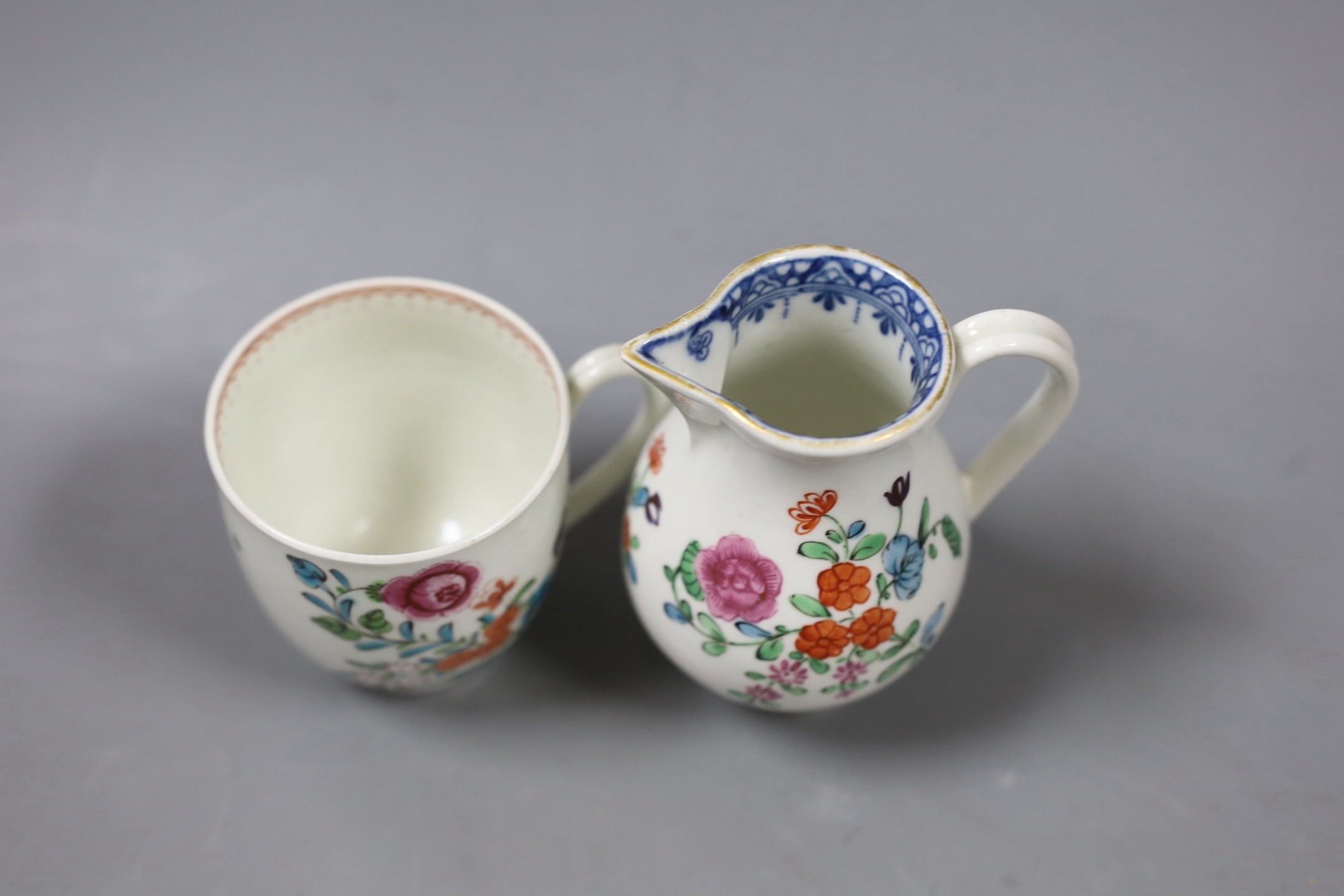 A Worcester sparrow beak jug, enamelled with flowers with an inner underglaze blue border and a similar coffee cup with a line loop and dot border. Tallest 9cm